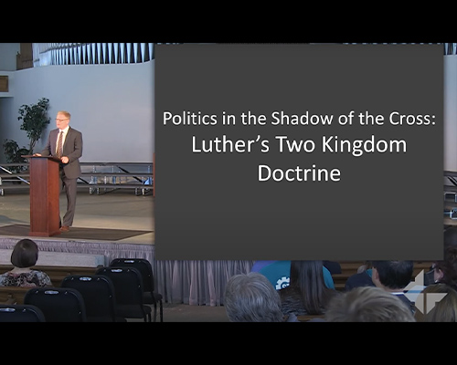 Theology professor speaking at a podium