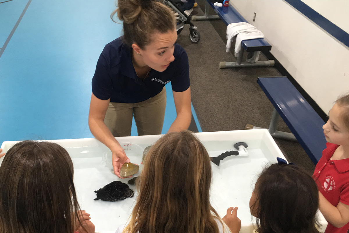 Female teaching children about the Marine Lab