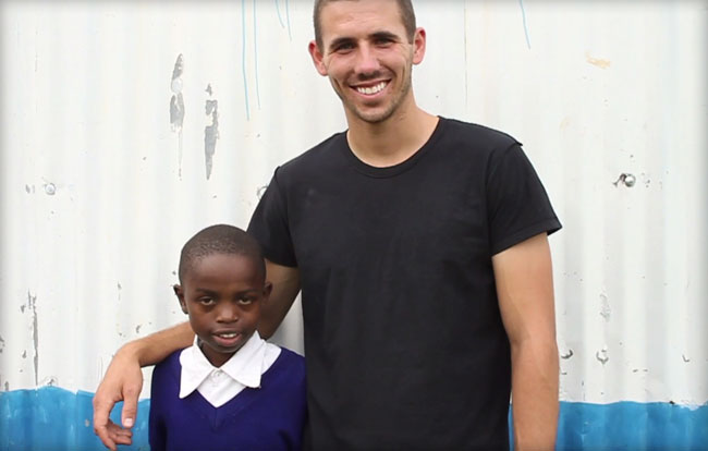 Sam Bretzmen and a young boy from Kenya